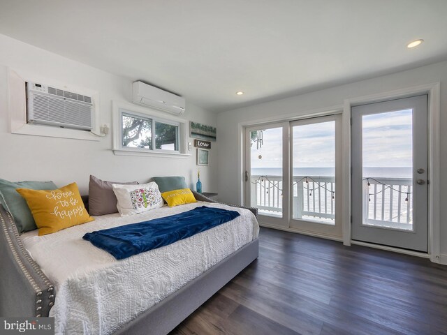 dining area with a water view and hardwood / wood-style floors