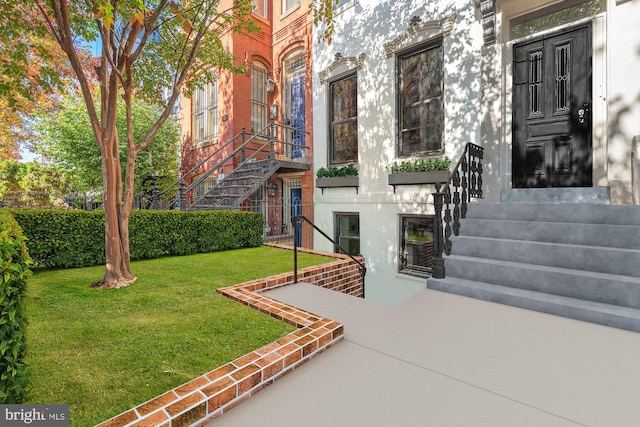 entrance to property featuring a yard