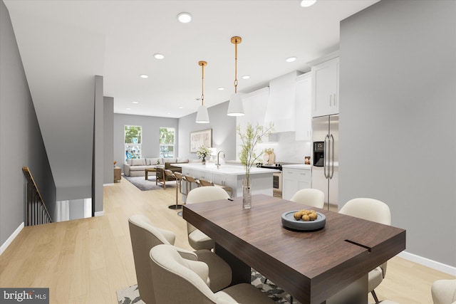 dining room with light wood-style flooring, baseboards, and recessed lighting