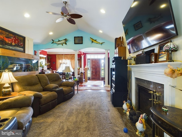 living room with decorative columns, a ceiling fan, lofted ceiling, carpet flooring, and a fireplace