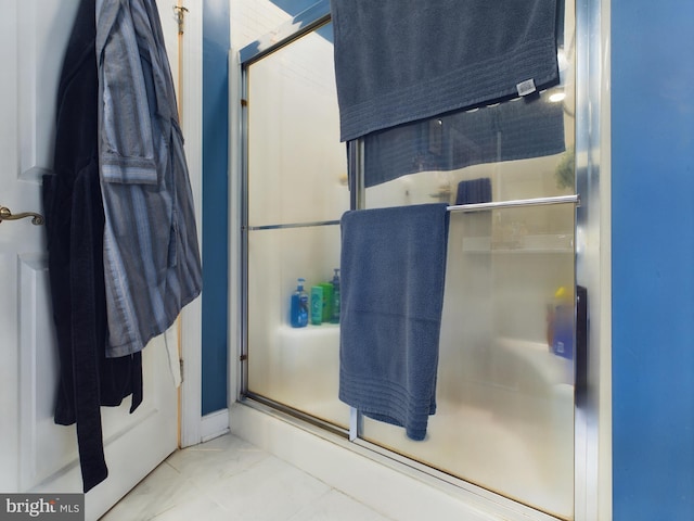 bathroom with walk in shower and tile patterned flooring