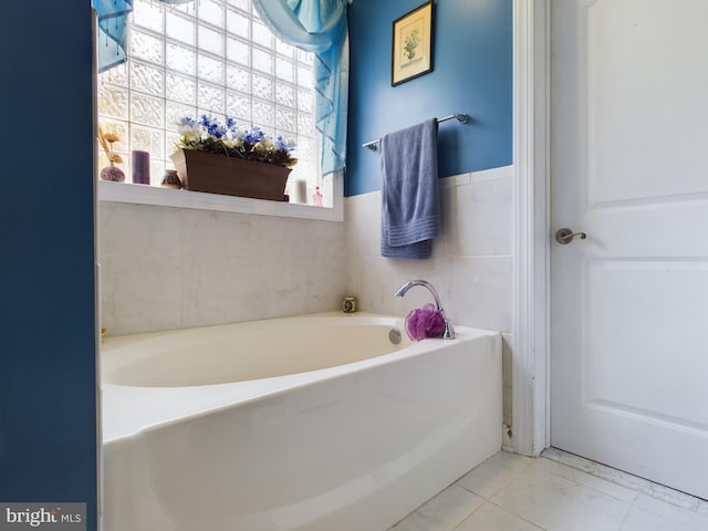 bathroom featuring a washtub and tile patterned floors