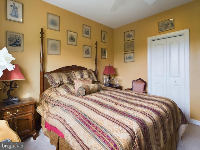 carpeted bedroom with ceiling fan and a closet