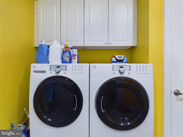 laundry area featuring cabinets and washing machine and dryer