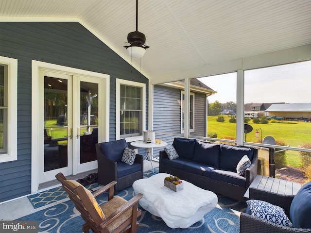 sunroom with lofted ceiling, ceiling fan, and french doors