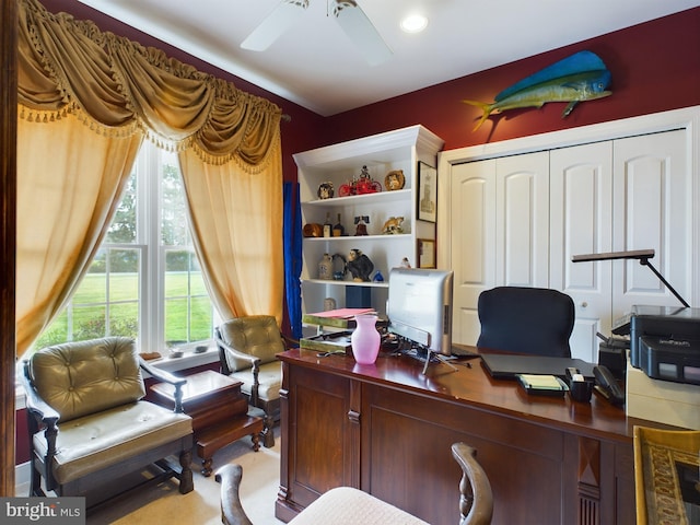 carpeted home office featuring ceiling fan