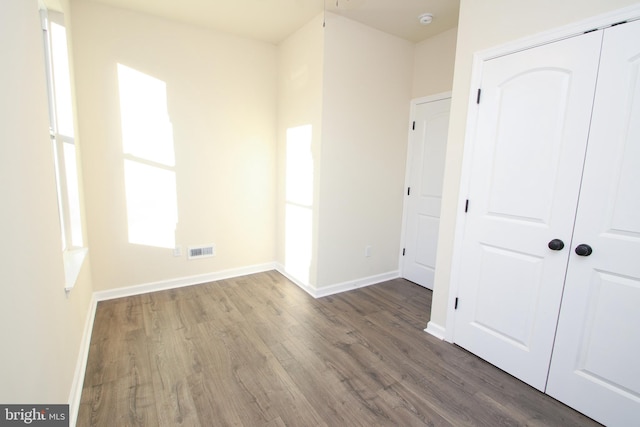 unfurnished bedroom featuring hardwood / wood-style floors and a closet