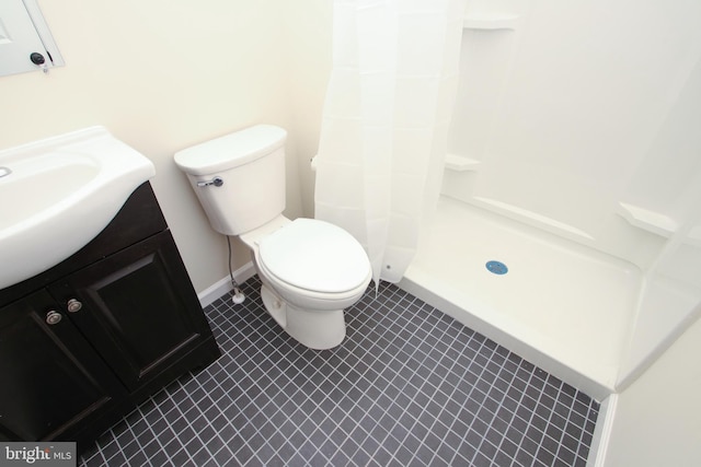 bathroom with curtained shower, toilet, tile patterned floors, and vanity