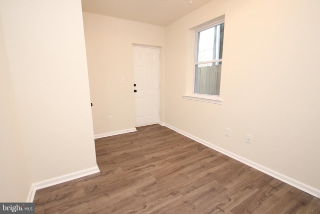 unfurnished room with hardwood / wood-style floors