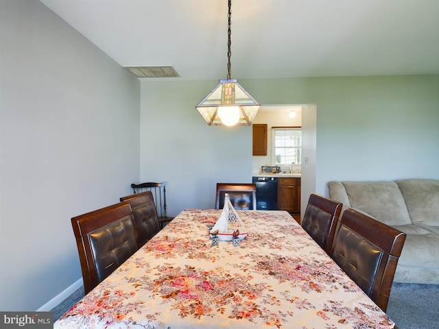 dining area featuring carpet flooring and sink