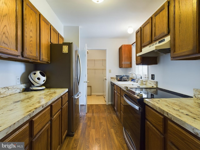 kitchen with sink, stainless steel appliances, and dark hardwood / wood-style floors