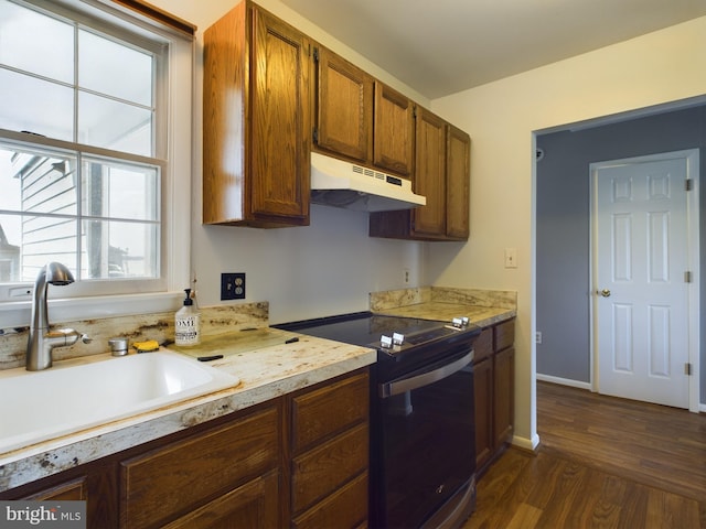 kitchen with range with electric stovetop, dark hardwood / wood-style flooring, and sink