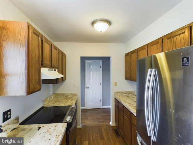 kitchen with stainless steel refrigerator, dark hardwood / wood-style flooring, and range