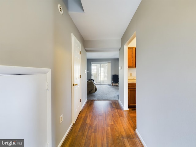 corridor featuring dark hardwood / wood-style floors