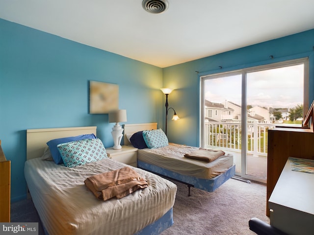 carpeted bedroom featuring access to exterior