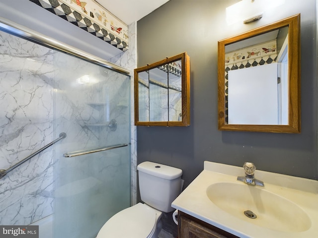 bathroom featuring vanity, toilet, and an enclosed shower