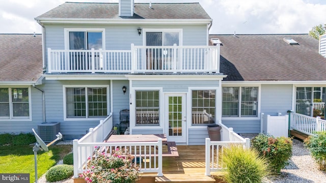 rear view of property featuring a balcony, a deck, and central air condition unit