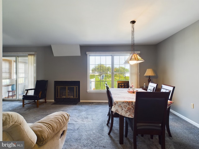 carpeted dining room featuring a wealth of natural light