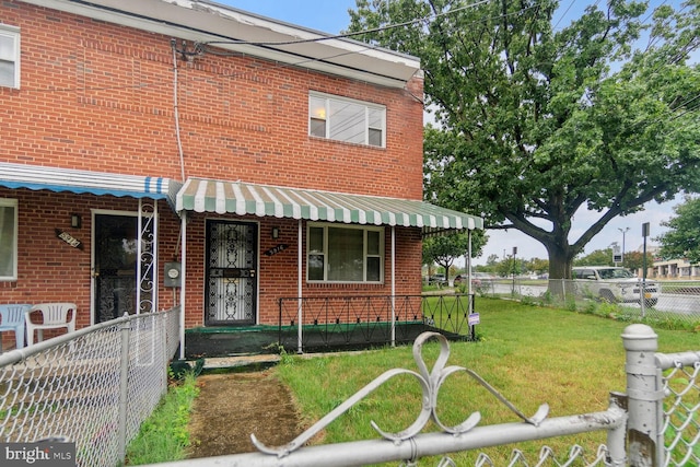 view of property featuring a front lawn