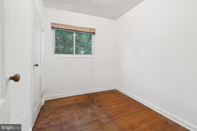 spare room with dark wood-type flooring