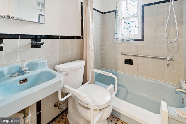 full bathroom with toilet, shower / bath combo with shower curtain, tile walls, tile patterned floors, and sink