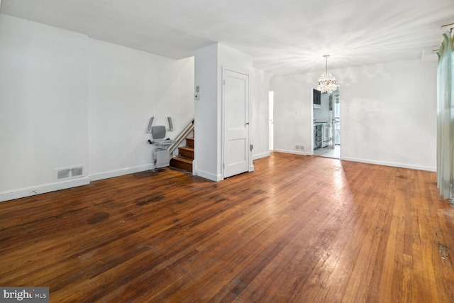 interior space with hardwood / wood-style floors and an inviting chandelier