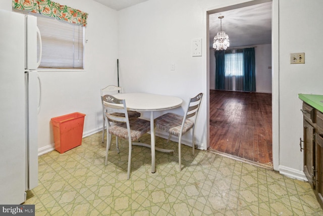 tiled dining area with an inviting chandelier