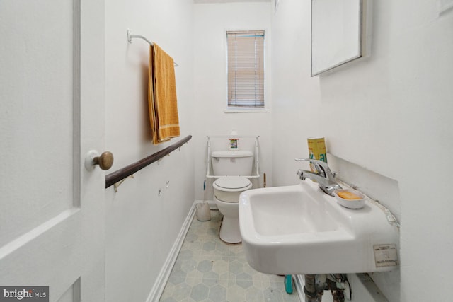 bathroom featuring sink, toilet, and tile patterned floors