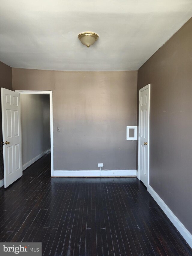 spare room featuring wood-type flooring