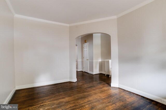 unfurnished room featuring radiator heating unit, hardwood / wood-style floors, and ornamental molding