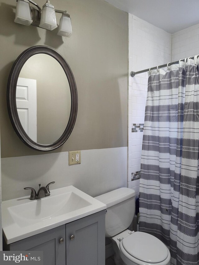 bathroom featuring toilet and vanity