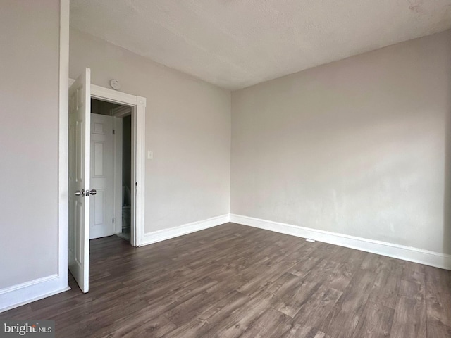 empty room featuring dark hardwood / wood-style floors