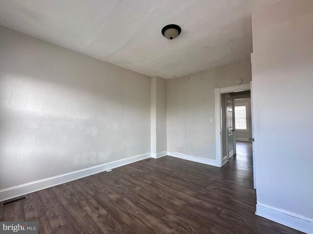 spare room featuring dark hardwood / wood-style flooring