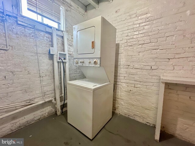 washroom with stacked washer / drying machine