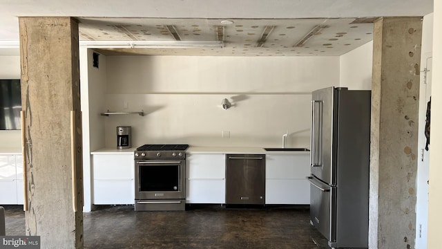 kitchen featuring stainless steel appliances, sink, and white cabinets