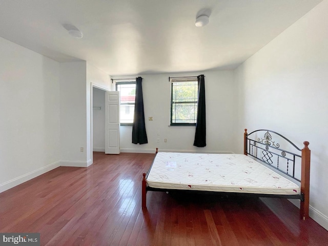 unfurnished bedroom with hardwood / wood-style flooring