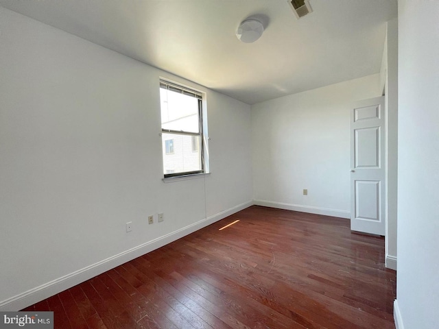 empty room with dark wood-type flooring