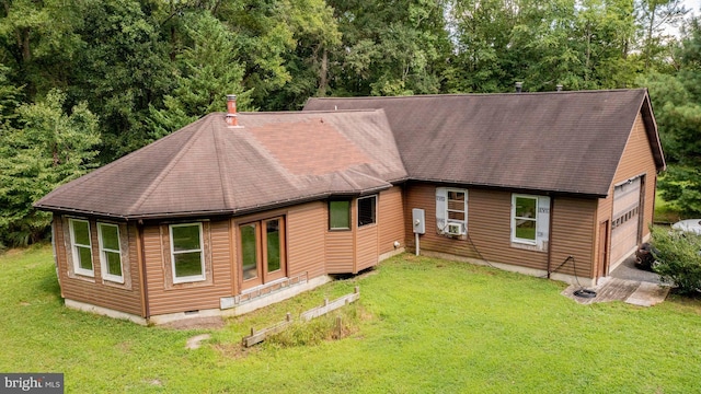 rear view of property featuring cooling unit and a yard