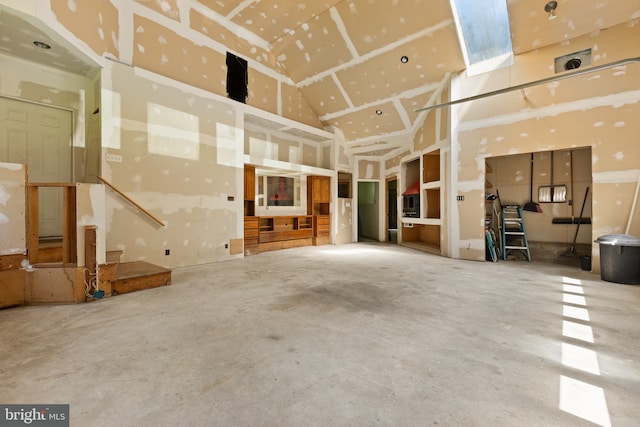 interior space with a towering ceiling and concrete floors