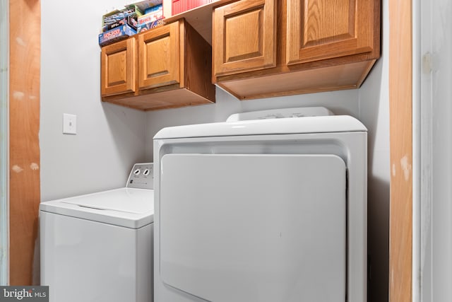 laundry room with cabinets and washer and dryer