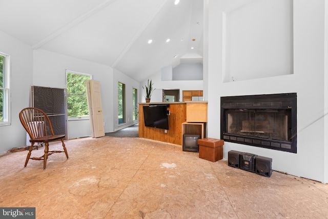 living room featuring high vaulted ceiling and beamed ceiling