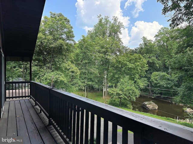 balcony with a forest view and a water view