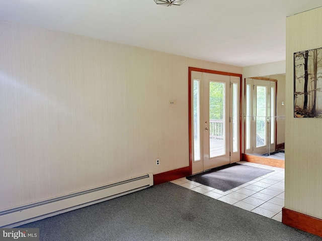 doorway to outside with a baseboard heating unit and tile patterned flooring