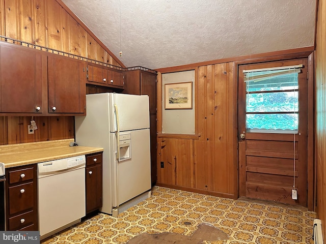 kitchen featuring a baseboard heating unit, wood walls, a textured ceiling, lofted ceiling, and white appliances