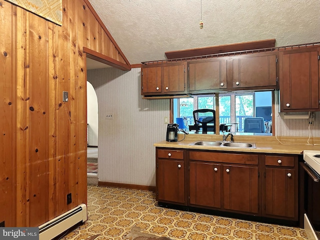 kitchen with sink, a baseboard radiator, white electric stove, wood walls, and a textured ceiling