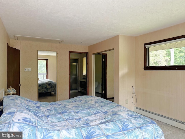 bedroom with a baseboard radiator, attic access, a textured ceiling, and a closet