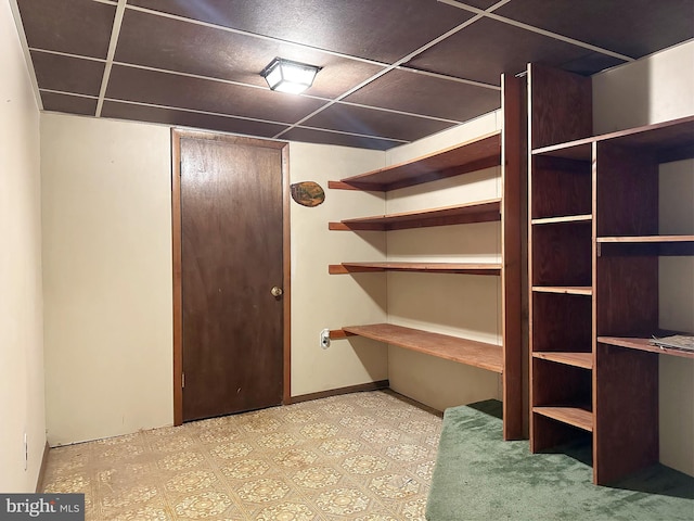 basement featuring a paneled ceiling