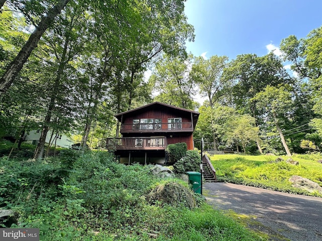chalet / cabin with stairway and a wooden deck