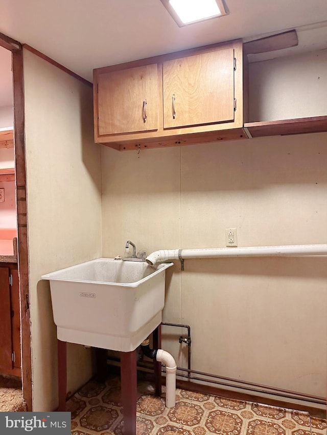 laundry area featuring cabinets