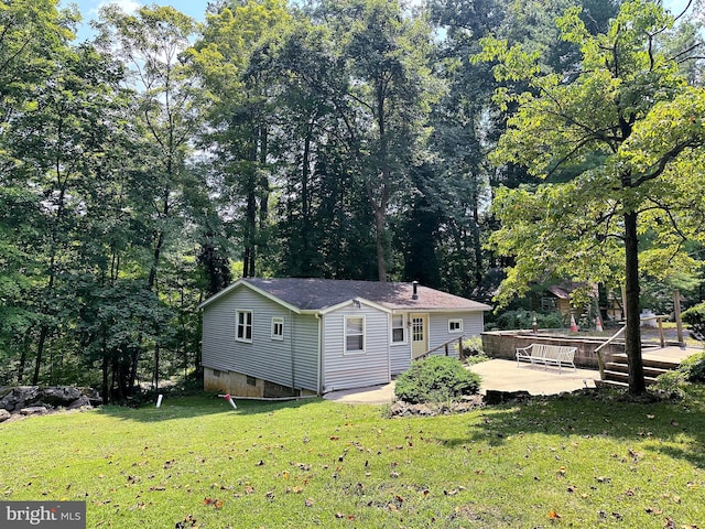 exterior space featuring a patio and a lawn